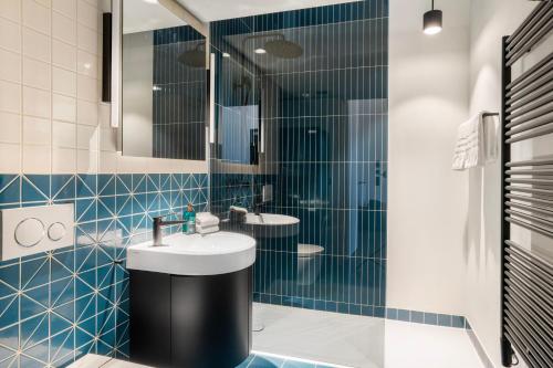 a bathroom with two sinks and a mirror at Starlight Loft Lucerne, World Above Chapel Bridge in Lucerne