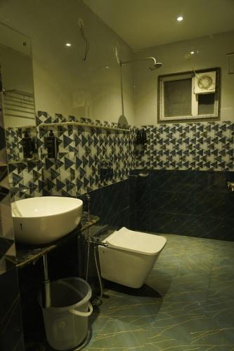 a bathroom with a sink and a toilet at Hotel Atithi Residency in Lucknow