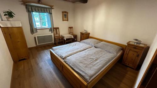 a bedroom with a large bed and a window at Kovárna in Nová Paka