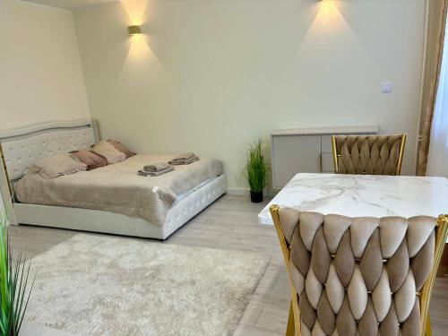 a bedroom with a bed and a chair at Leo Apartament in Konin
