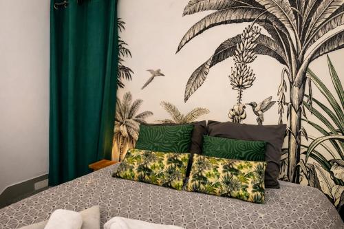 a bedroom with a bed with a mural of palm trees at Suite historique classée Avignon intra-muros in Avignon