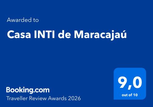 a blue sign with the words casa intent de maracaza at Casa INTI de Maracajaú in Maracajaú