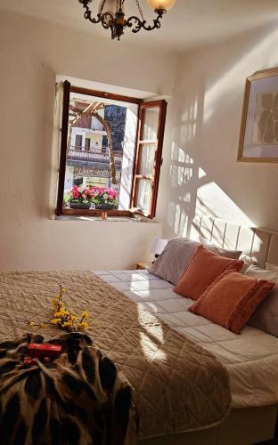 a bedroom with a large bed and a window at Alpine View Varzo - Train Station in Varzo