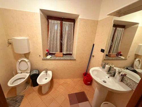 a bathroom with a toilet and a bidet and a sink at Alpine View Varzo - Train Station in Varzo