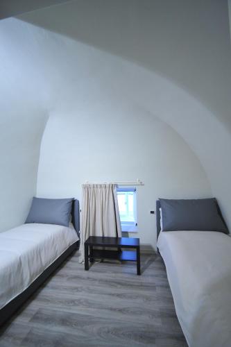Postel nebo postele na pokoji v ubytování Gatto Bianco House