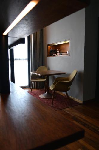 a dining room with two chairs and a table at Dos Casas Hotel & Spa in San Miguel de Allende