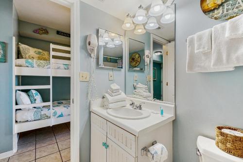 a bathroom with a sink and a mirror at Plantation Palms 6305 in Gulf Highlands