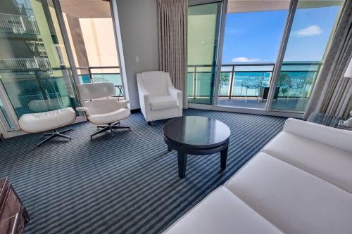a living room with a couch and chairs and a table at Seaside condo w hot tub & private balcony in Myrtle Beach