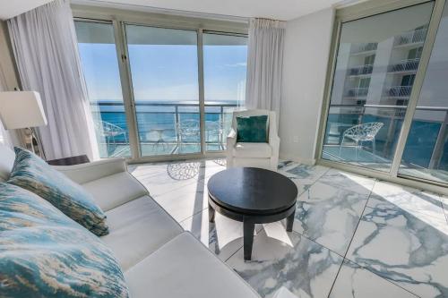 a living room with a couch and a table at Amazing Oceanfront 2BR condo with pools and views in Myrtle Beach