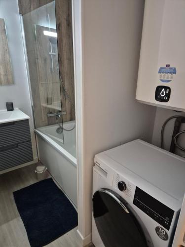a washing machine in a bathroom with a shower at Ty Joty in Perros-Guirec