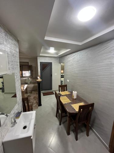 a kitchen and dining room with a table and a sink at yallah surf house in Taghazout