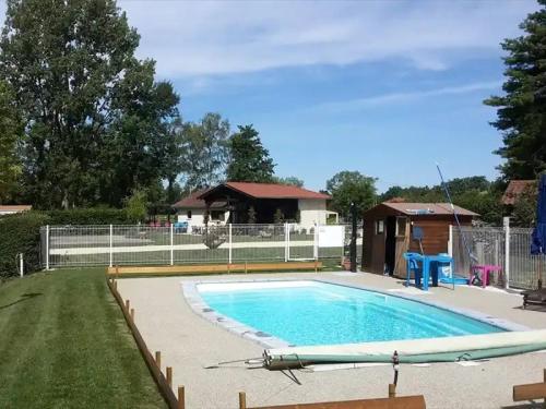a swimming pool in a yard with a fence at ZEcamping 3 étoiles familial pet friendly avec piscine et restaurant in Sandrans