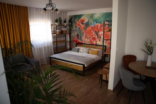 a bedroom with a bed and a painting on the wall at Sauna Cafee & Beds in Český Těšín