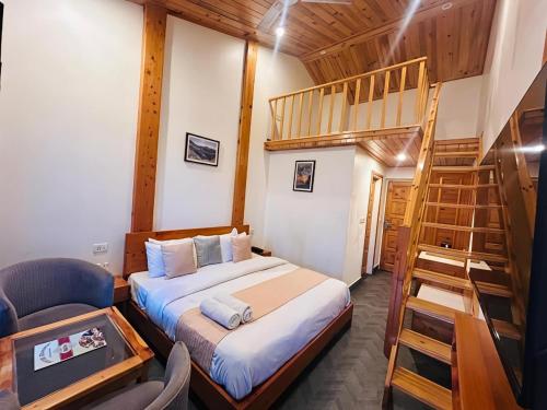 a bedroom with a bunk bed and a staircase at The Grand Dwaper A- Luxury Rooms & Parking Walking Distance From Mall Road in Mussoorie