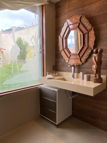 a bathroom with a sink and a mirror on the wall at Restau de Marambaia in Barra de Guaratiba