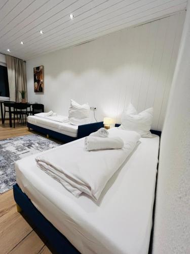 two beds in a room with white walls at Ferienwohnung Südtor 2 in Geisingen