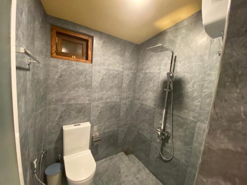 a bathroom with a toilet and a shower at Elite Nest in Ahangama