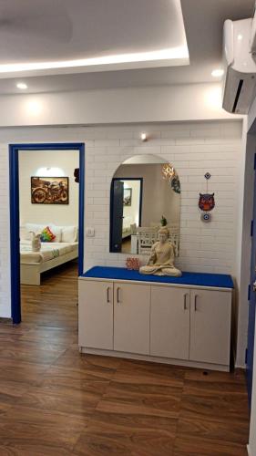 a room with a counter with a mirror and a bed at Feel Goa at Poolview 2BHK Luxury Apartment in Arpora
