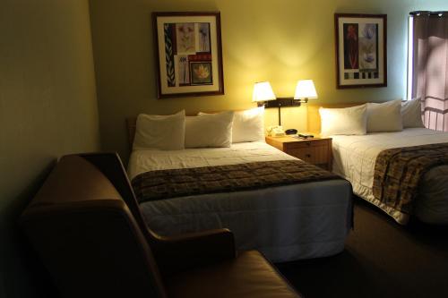 a hotel room with two beds and a window at Big Pines Mountain House in South Lake Tahoe