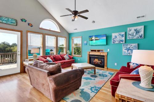a living room with a couch and a fireplace at 2000 - Pipers Paradise in Duck