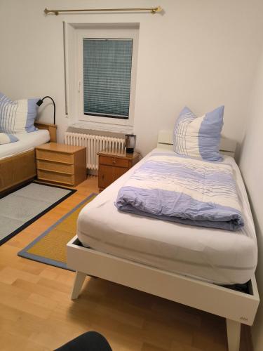 a bedroom with a large bed and a window at Weinbergblick in Kirchheim am Neckar