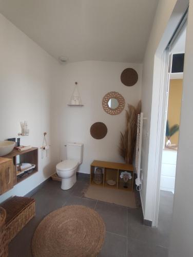 a bathroom with a toilet and a sink at O'me Wally in Galargues
