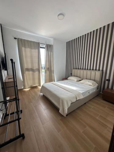 a bedroom with a bed and a large window at Los Magicos Apartments, Punta Cana in Punta Cana
