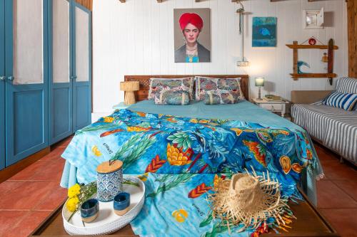 a bedroom with a bed with a blue comforter with food on it at Cabin in front of idyllic majanicho beach in Majanicho
