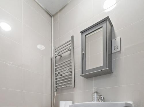 a bathroom with a sink and a mirror at Cheerful Central Studio - 2 in Leicester