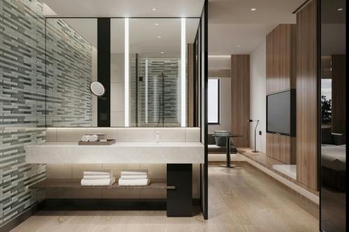 a bathroom with a sink and a mirror at Fairfield by Marriott Hengdian in Dongyang