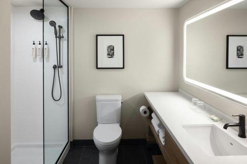 a bathroom with a toilet and a sink and a shower at Delta Hotels by Marriott Halifax Downtown in Halifax