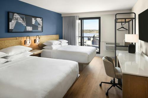 a hotel room with two beds and a desk at Delta Hotels by Marriott Halifax Downtown in Halifax