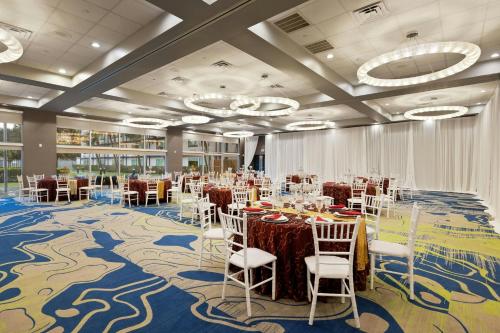 a banquet hall with tables and chairs in a room at Verta Hotel McAllen in McAllen