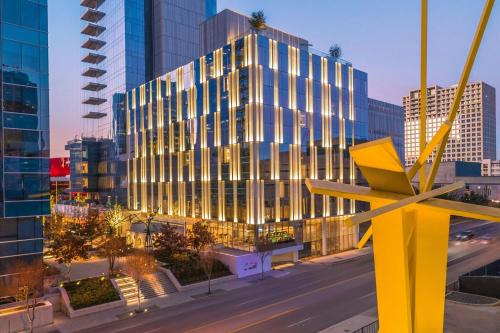 a tall building with a yellow sculpture in front of it at HALL Arts Hotel, Dallas, Autograph Collection in Dallas