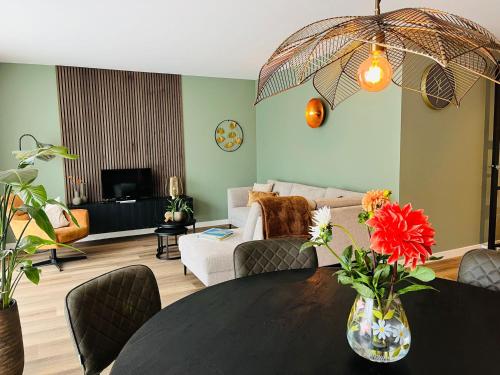 a living room with a table and a couch at Luxe appartement 4 personen #2