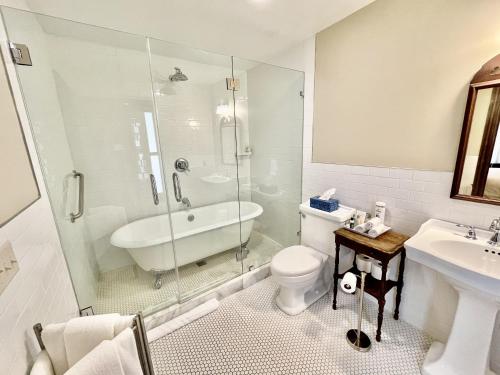 a bathroom with a tub and a toilet and a sink at Dartmouth House Inn in Rochester