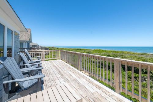 a deck with chairs and the ocean in the background at Run-A-Way Bay - Duck, Sanderling, Oceanfront, Ocean View, Hot Tub, Community Pool, Tennis in Duck