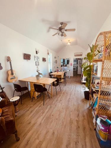 a living room with a table and a ceiling fan at Santa Cruz Hostel in Santa Cruz