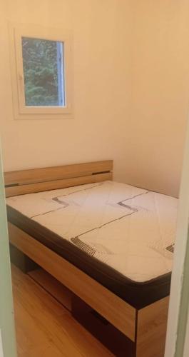 a bed in a room with a window at Aurora in Montauroux