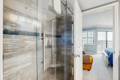 a bathroom with a shower with a glass door at OIB74 Kat Cove 2 in Ocean Isle Beach