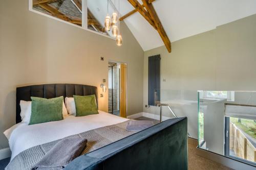 a bedroom with a large bed with green pillows at 1 Bed in Tebay oc-m29886 in Tebay