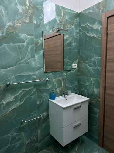 a bathroom with a sink and a mirror at Binario104 in Naples