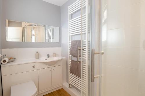 a white bathroom with a sink and a shower at 2 Bed in Cromer oc-t29986 in Cromer