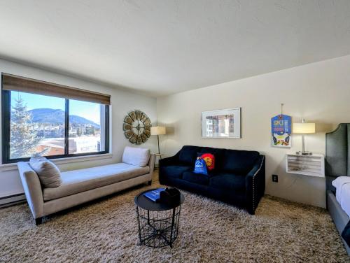 a living room with a couch and a chair at Edgewater 1436 by SummitCove Lodging in Colorado in Keystone