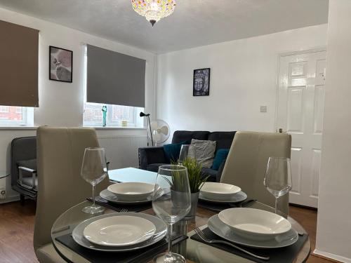 a dining room with a table with plates and wine glasses at FilmonHomes in Oldbury