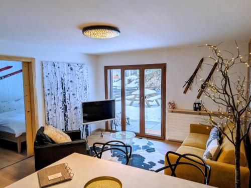 a living room with a couch and a table at Nendaz Nest - Appartement moderne & confortable au cœur de Nendaz - 4 Vallées in Nendaz