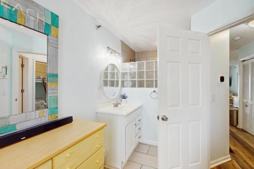 a bathroom with a sink and a mirror at OIB88 PierSide Paradise in Ocean Isle Beach