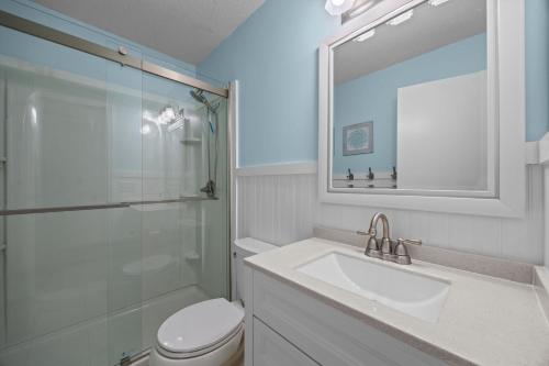 a bathroom with a toilet and a sink and a shower at OIB90 Endless Summer in Ocean Isle Beach