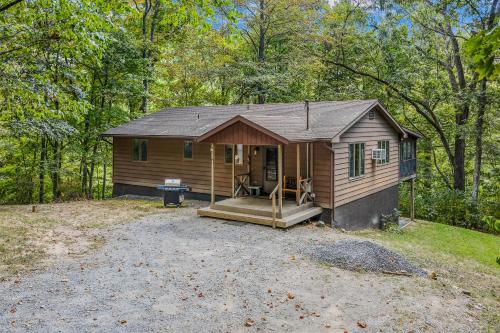 a small cabin in the middle of the woods at Chesnutt Cabin - Riverfront, Fire Pit, Game Room, Wifi, Screen Porch, View, King Bed in Morton Grove