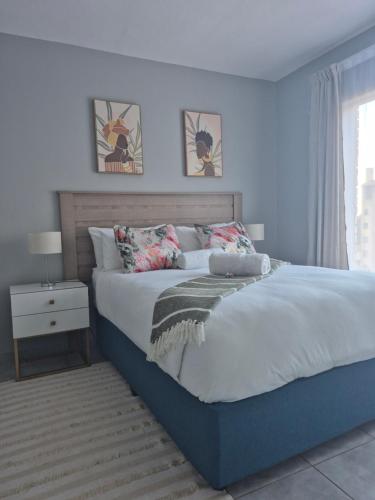 a bedroom with a large bed and a window at Mlangeni's Rest in Centurion